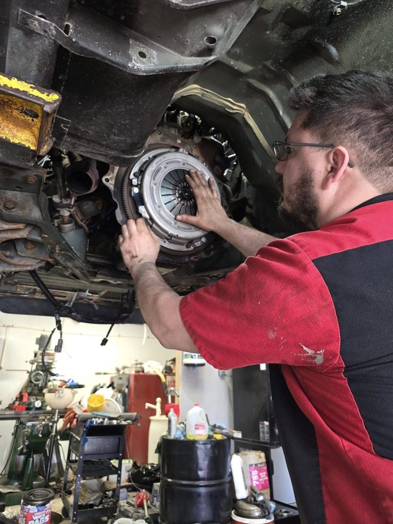 Technician fitting a clutch assembly at TinJToo Auto Repair